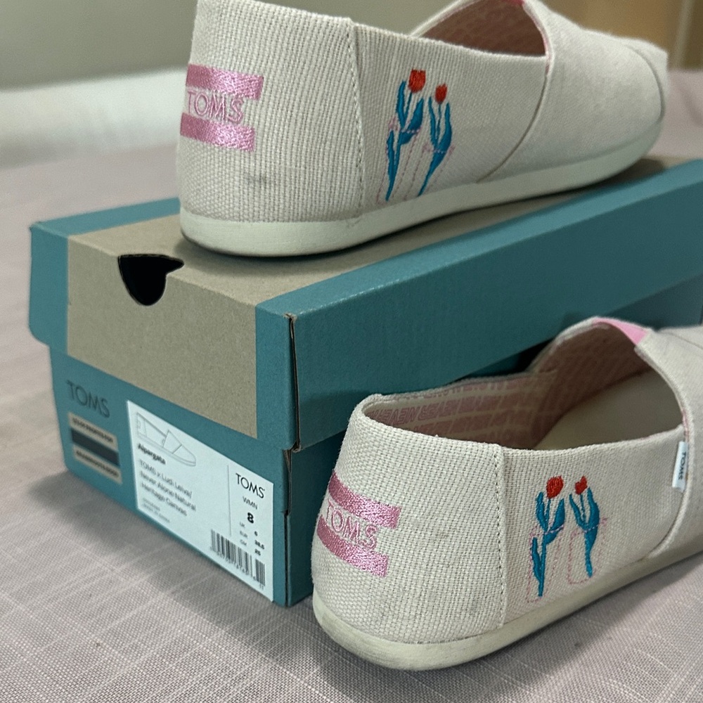TOMS Cream Slip-Ons with Blue and Pink Embroidery